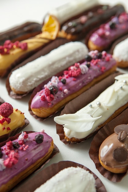 Set of several eclairs with various fillings 