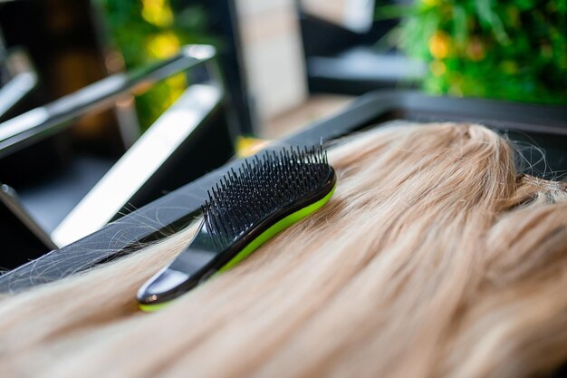 A set of several hair extension tools for a blonde woman in a beauty salon