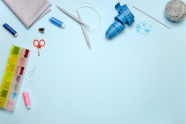 Set of sewing accessories on a blue background, top view