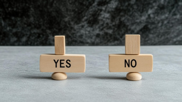 A set of silver scales displays a wooden block labeled YES on one side and a smaller cube teetering on the edge of the NO side illustrating decisionmaking