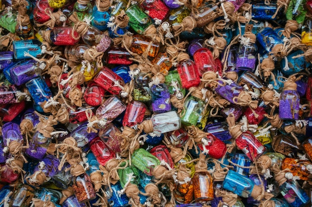 Set of small glass decorative bottles with colored sand