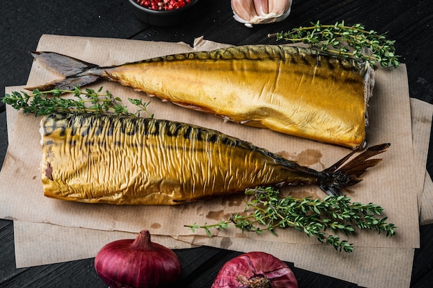 Set of smoked fish mackerel, on black wooden table background