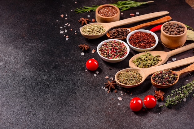 A set of spices and herbs. Indian cuisine. Pepper, salt, paprika, basil and other. Top view.