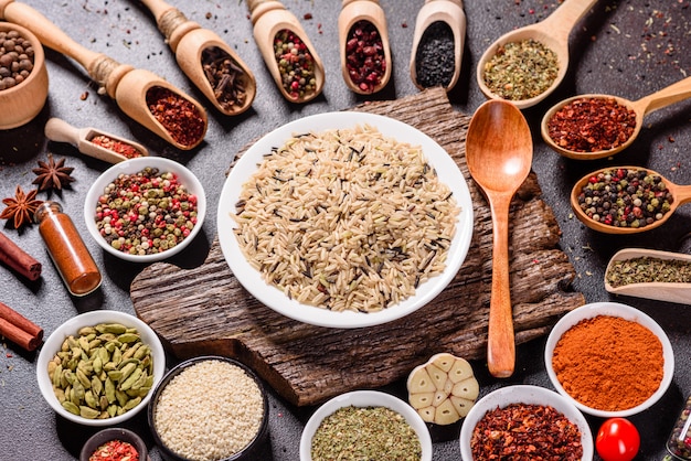 A set of spices and herbs. Indian cuisine. Pepper, salt, paprika, basil. Top view.