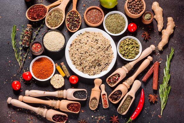 A set of spices and herbs. Indian cuisine. Pepper, salt, paprika, basil. Top view.