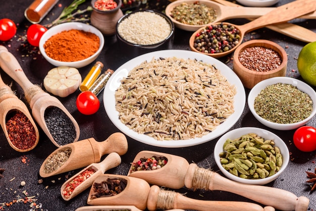 A set of spices and herbs. Indian cuisine. Pepper, salt, paprika, basil. Top view.