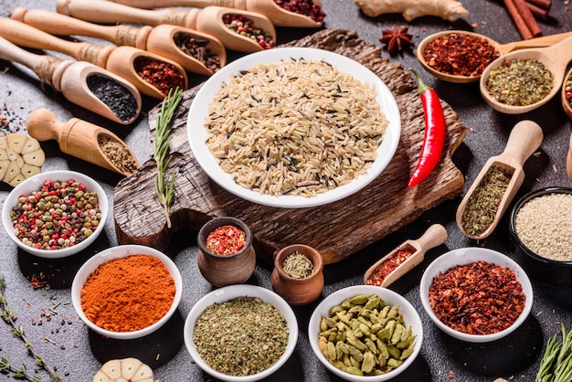 A set of spices and herbs. Indian cuisine. Pepper, salt, paprika, basil. Top view.