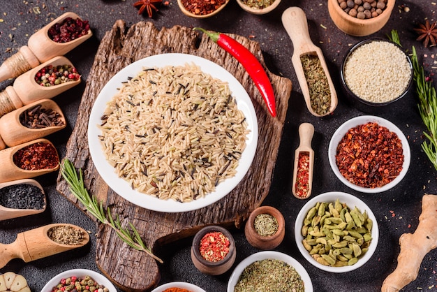 A set of spices and herbs. Indian cuisine. Pepper, salt, paprika, basil. Top view.