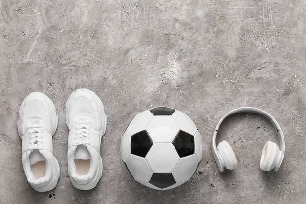 Set of sport equipment on grey floor with copy space