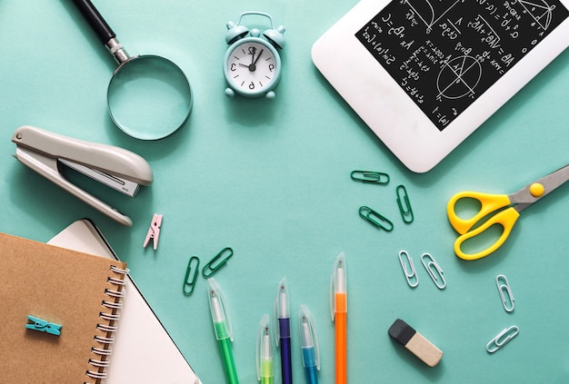 Set of stationery on a blue paper background. Exam readiness concept and back to school.Business concept. Flat lay.