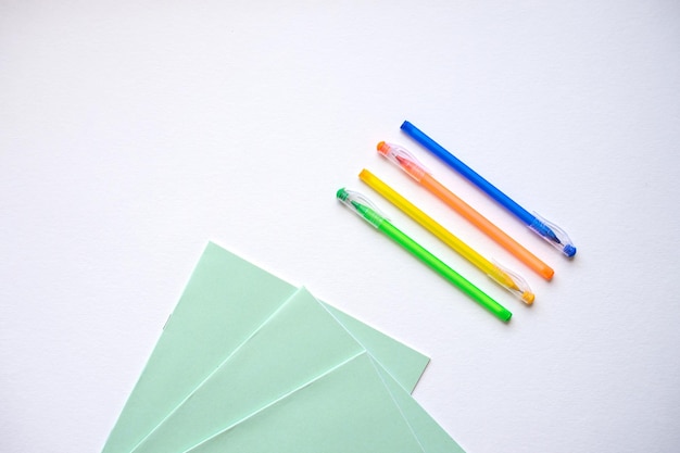 A set of stationery on a white background pens of different colors