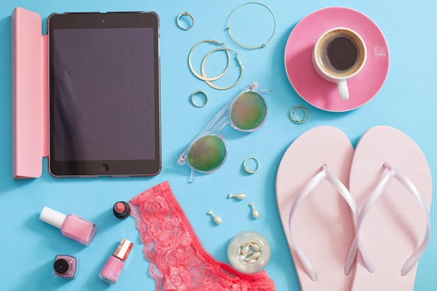 Set of  stylish woman accessories on blue background.