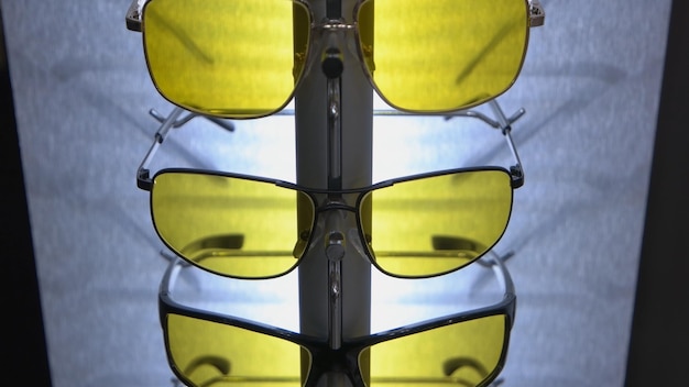 Set of stylish yellow and black sunglasses spectacles accessories closeup