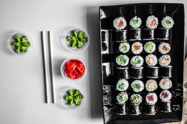 Set of sushi and maki roll on dark background Top view