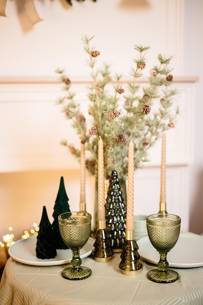 A set table in the living room near the fireplace Romantic New Year's atmosphere by the fireplace New Year interior decor in the house