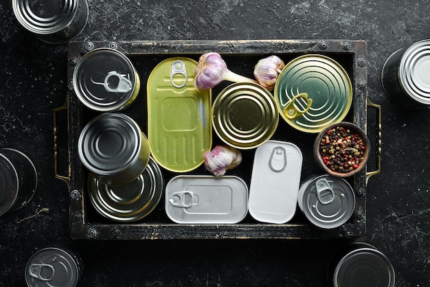 Set of tin cans with food in wooden box Top view Free space for your text