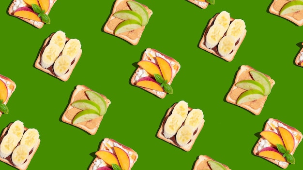 Set of toasted bread with peach apple and banana on green background Pattern