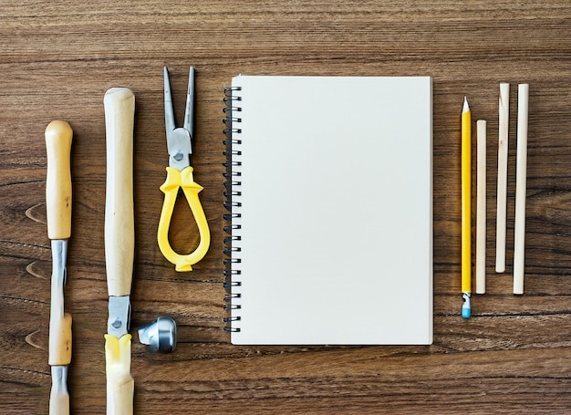 Set of tools notebook pencil for shoemaker on a wooden background