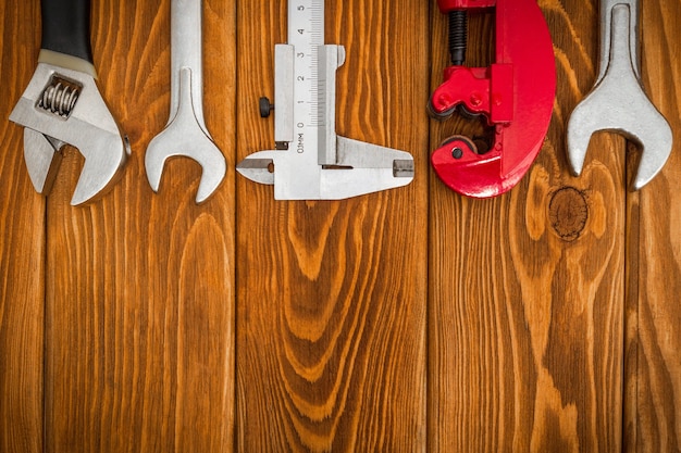 Set of tools for plumber on vintage wooden boards