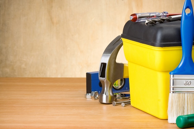 Set of tools and toolbox on wood