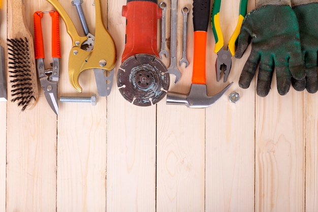 Set of tools on wooden background.