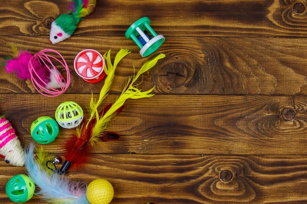 Set of toys for cat on wooden background Top view copy space