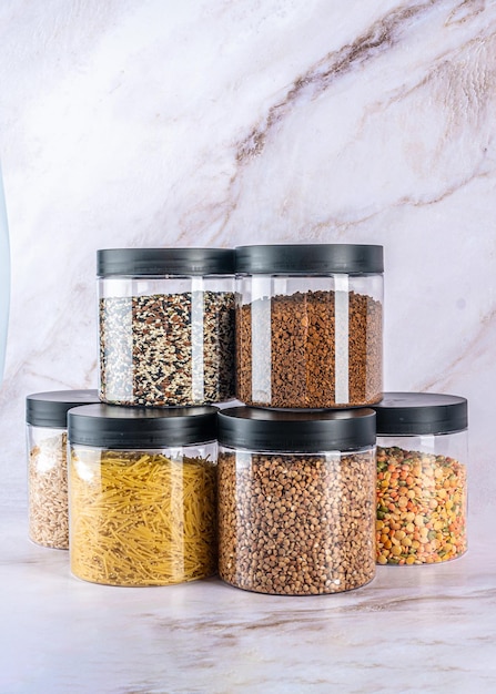 A set of transparent cans for dry food on a light background