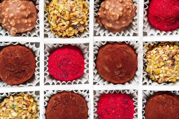 A set of truffle sweets with different fillings in a box closeup