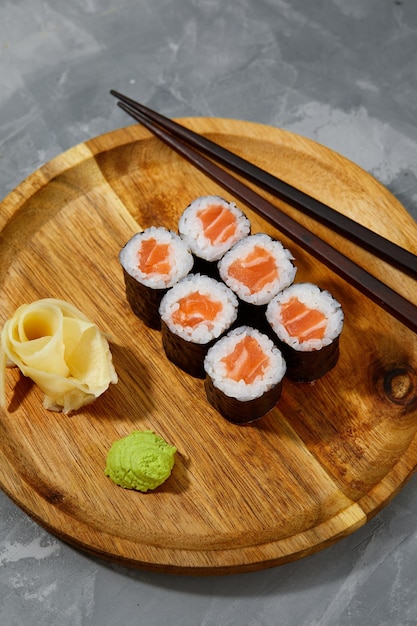 Set of tuna sushi rolls on black desk background