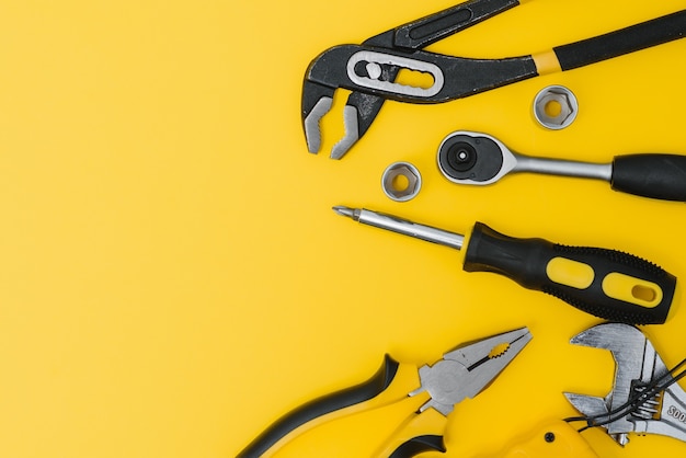 Set of various construction tools. Tools for home repair. Work at a construction site. On a yellow background. Flatly. Flatlay.