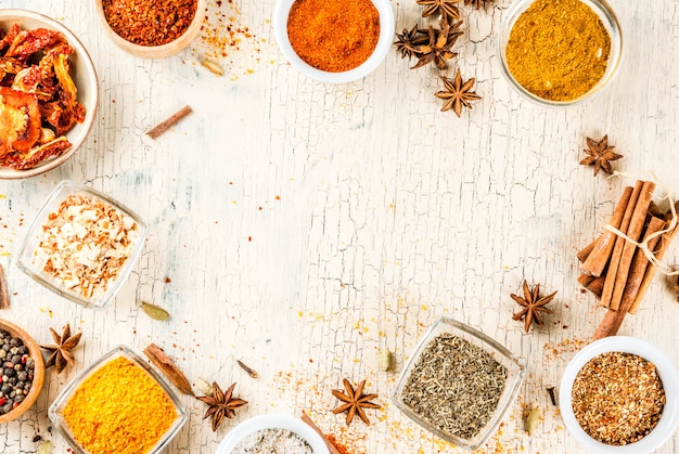 Set of various spices on light concrete .  .