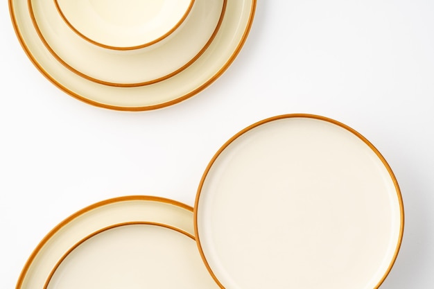 A set of white and brown ceramic plate and bowl on a white background Top view