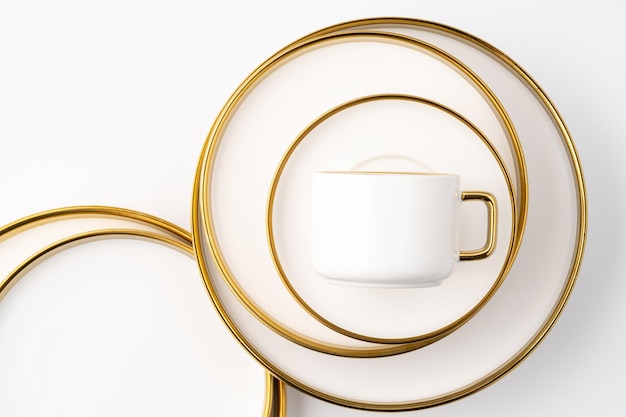 A set of white and brown ceramic plate and cup on a white background Top view