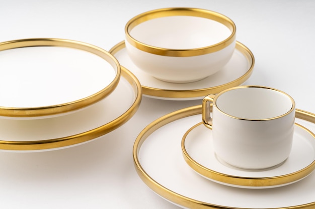 A set of white and brown ceramic plate and cup on a white background