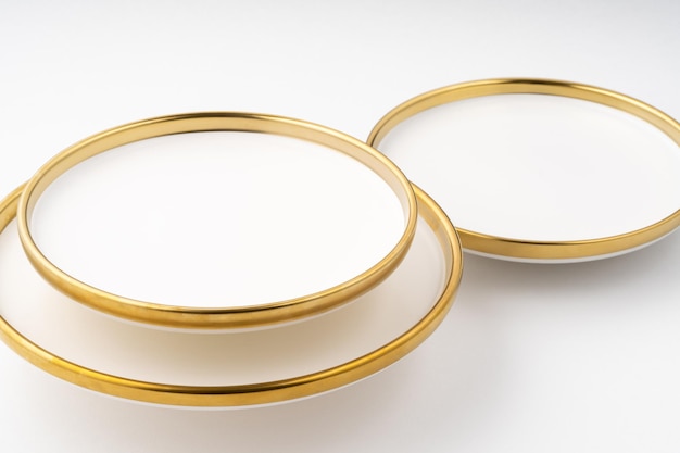 A set of white and brown ceramic plates on a white background