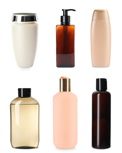 Set with different bottles of shampoo on white background