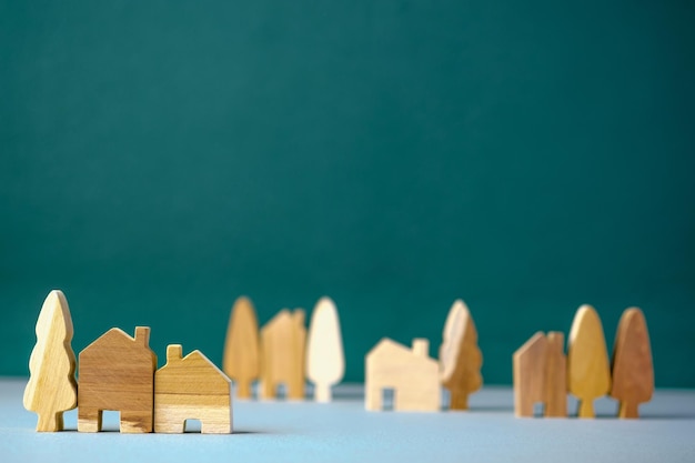 Set of wooden house and tree decoration in village on grey floor and green background