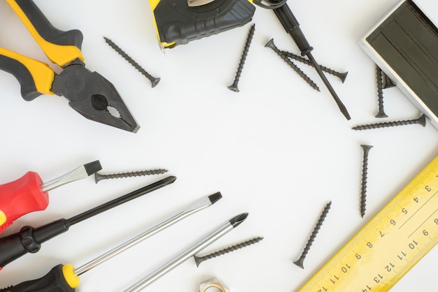 A set of working tools on a white background Hardware store Closeup Construction industry