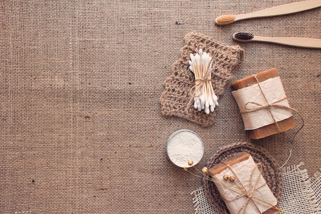 Set of zero waste bathroom essentials on burlap texture with copyspace