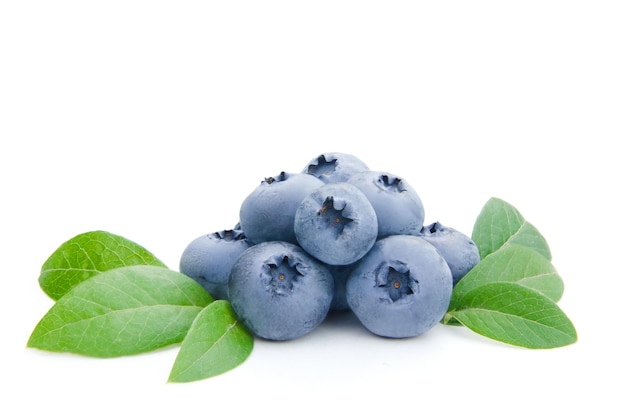 Several blueberries with leaves isolated on white background