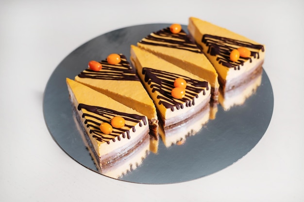 Several cakes are symmetrically laid out on a plate Food delivery Homemade baking Side view