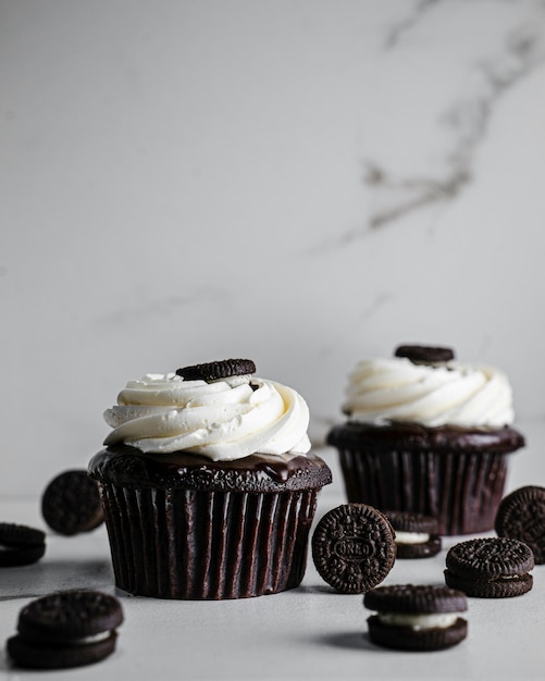 several cupcakes with white frosting and chocolate chips on them