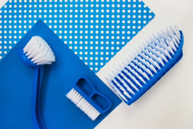 Several different cleaning brushes on a white background Convenient equipment for cleaning the house Hand brush View from above Space for text