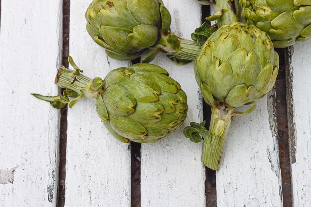 Several fresh artichokes on the table