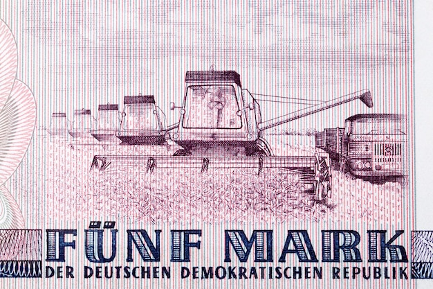 Several harvesting machines from East German money