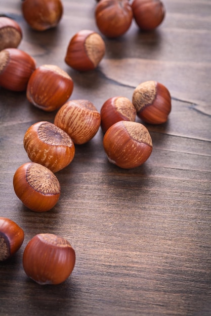 Several hazelnuts on vintage wooden board food and drink concept