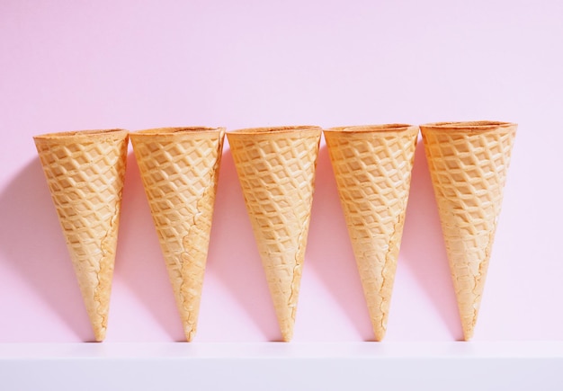 Several ice cream waffle cups on a colored background with a clear shadow