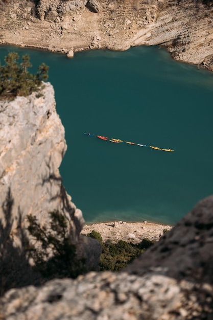 Several kayaks float on the emerald lake in the mountains. Congost de Mont Rebei Spain