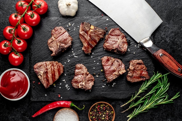 several mini Grilled beef T-Bone steaks on stone table