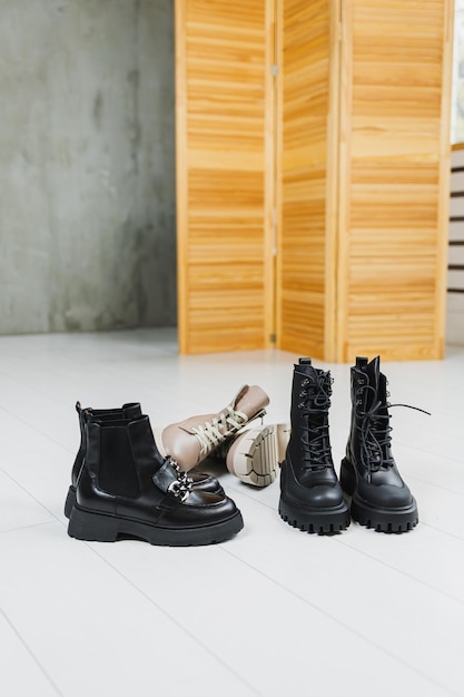 Several pairs of shoes lie on the floor Winter black leather women's shoes